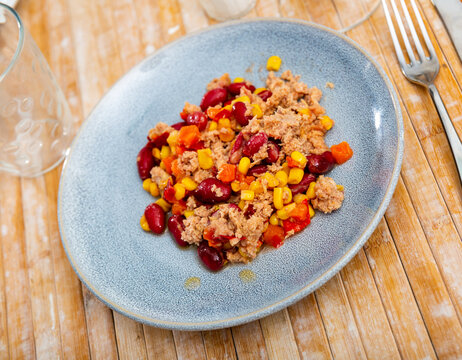 Plate of light and nutritious salad made with tender crushed tuna, kidney beans, sweet corn, and fresh vegetables served in simple style. Mexican cuisine..