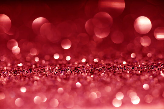 Pink, red white glittering Christmas lights. Blurred abstract bokeh background.