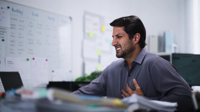Heart Attack and severe Chest Pain caused by Cardiovascular failure in an Overworked man facing Stress, leading to a medical Emergency and Cardiac Arrest.