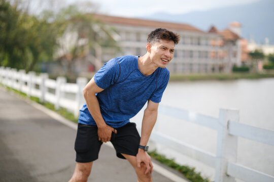 Athletic man experiencing groin pain while exercising outdoors, illustrating hernia symptoms, sports injury, and the importance of early medical attention.