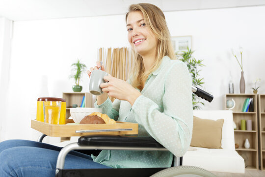 woman in a wheelchair having breakfast