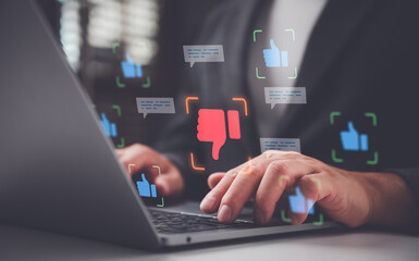 Fototapeta premium Businessman using laptop with virtual icons for customer feedback, survey, and social media sentiment. Concept of reputation management, consumer review analysis, and online rating experience.