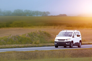 Fototapeta premium Spacious MPV family car driving on country road