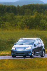 Fototapeta premium Crossover MPV family vehicle on open motorway