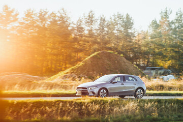 Silver car on open countryside road