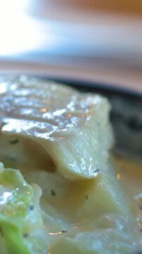 Close Up Spoon Lifting Flaky Fish from Creamy White Soup