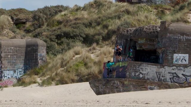 Graffiti Covered World War II Bunker on Sandy Beach Dunes