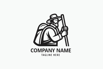 Obraz premium Silhouette shows a hiker with a backpack and walking stick, standing before two mountains