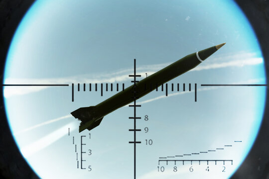 Military missile in the sky captured by air defense sight reticle during interception above clouds