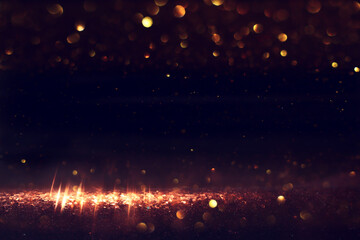 abstract glitter black and gold lights background. de-focused