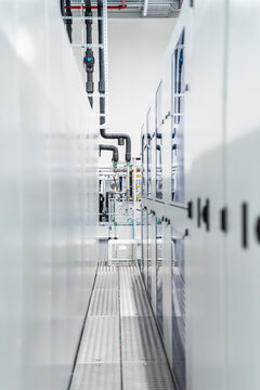 Narrow space between machinery inside modern factory, Stuttgart, Germany