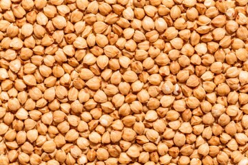 Fototapeta premium Raw Buckwheat Groats Flat Lay Macro Texture Warm Beige Background for Design