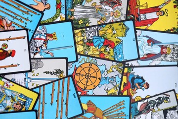 Big pile of different classical tarot cards on table. Pattern of tarot cards with traditional standard meanings