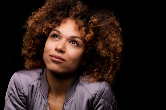 Portrait of woman in front of black background