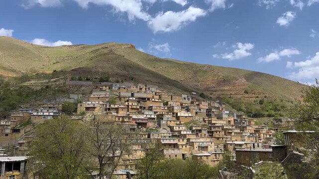 hillside village in Iran rural town countryside scenic Kurdish landscape natural adobe house traditional architecture terraced aerial scenic picturesque green hills colorful roofs charming unique view