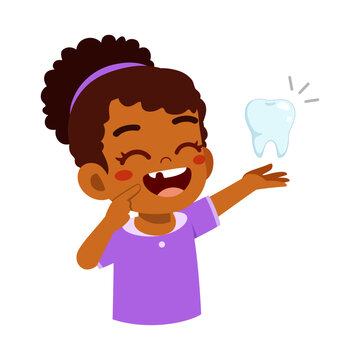 Smiling African American girl happy showing her missing front teeth and holding up a glowing tooth