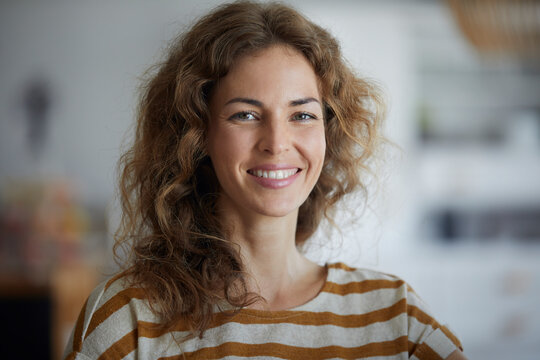 Beautiful woman smiling while standing at home