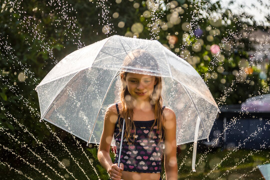 Portrait of daydreaming girl with umbrella