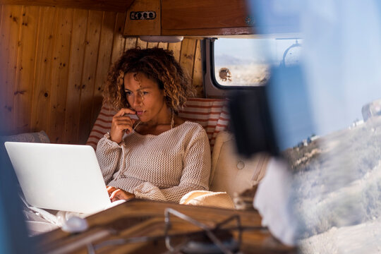 Spain, Tenerife, woman using laptop in van
