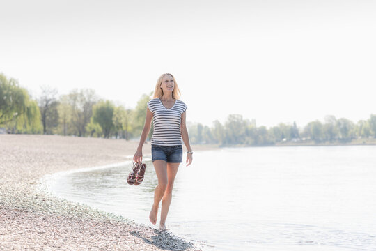 Smiling mature woman wading in a river