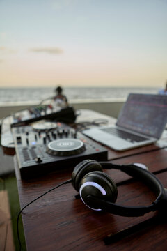 Headphones lying on table in front of mixing board