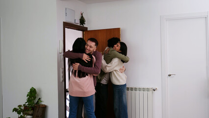 Friends arrival home embracing, welcoming each other happiness