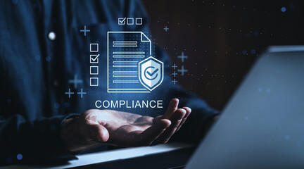 Business compliance concept with holographic checklist and shield above open hand on dark...