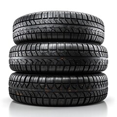 Stacked car tires in a bright studio setting. Black rubber tread designs visible against a white background with reflection