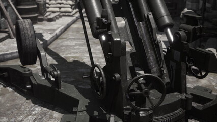 A large historical cannon stands prominently in an ancient fort, its wheels resting on stone. Bright daylight highlights its metallic structure against a backdrop of weathered walls and cobblestones. © icetray