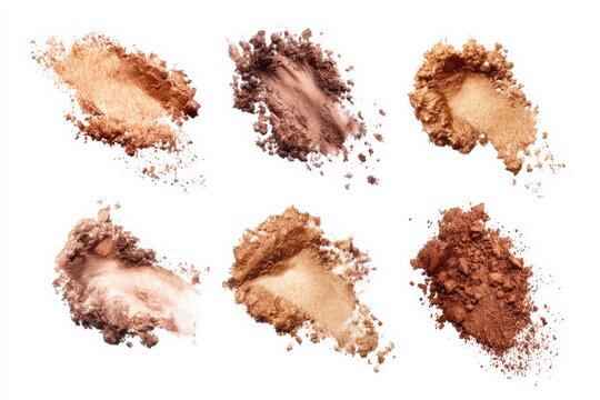 Assorted bronze and gold makeup powders on white background