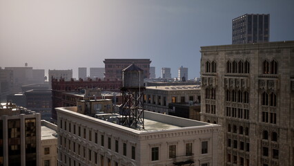 Dusk settles over the city, casting a warm glow on historic structures. A weathered water tower stands tall, surrounded by modern architecture, creating a blend of old and new. © icetray