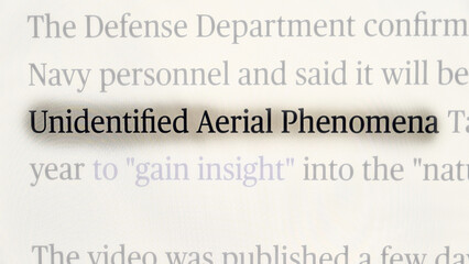 Close-up of a news headline highlighting the term &ldquo;Unidentified Aerial Phenomena,&rdquo; referencing official statements from the U.S. Defense Department about investigations into mysterious aerial sighting
