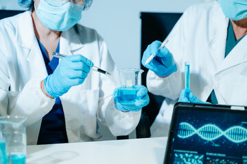 Fototapeta premium Scientists performing DNA genome analysis using digital tablet interface in biotechnology laboratory for medical research, genetics, pharmaceutical innovation and AI diagnostics.
