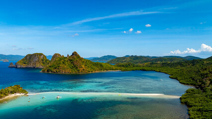 Aerail view of tropical exotic island sand bar separating sea in two with turquoise in El Nido, Palawan, Philippines.	