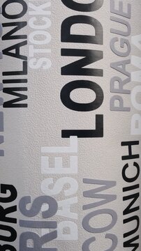 a modern wallpaper design characterized by an urban typography pattern of world city names