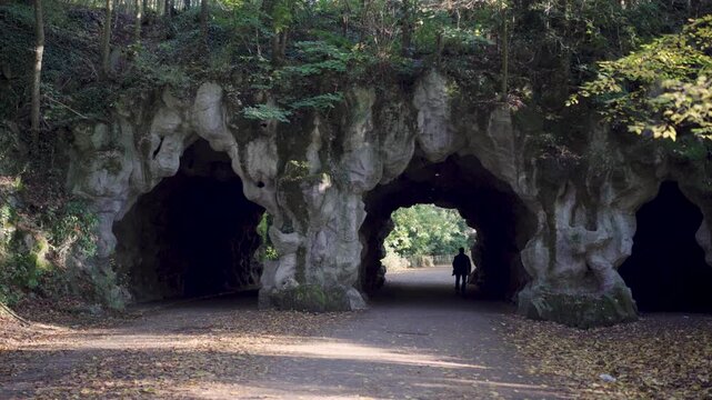 Person walking through grotto tunnels in park in Ghent Belgium