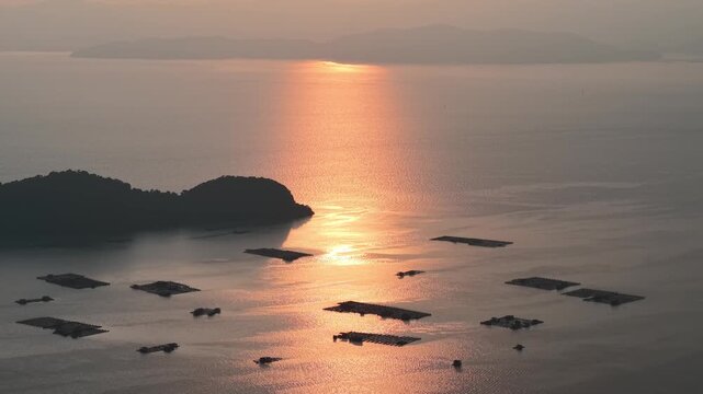 Drone view highlights kelong near Pulau Aman with fishing nets and boats nearby.