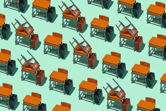 Repeated pattern of empty toy school desks with chairs on tables symbolizing absenteeism