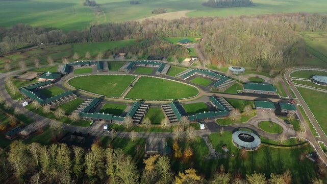 Aerial view of premium horse racing paddocks and state of the art stables in Newmarket UK illustrating the heart of British thoroughbred racing.