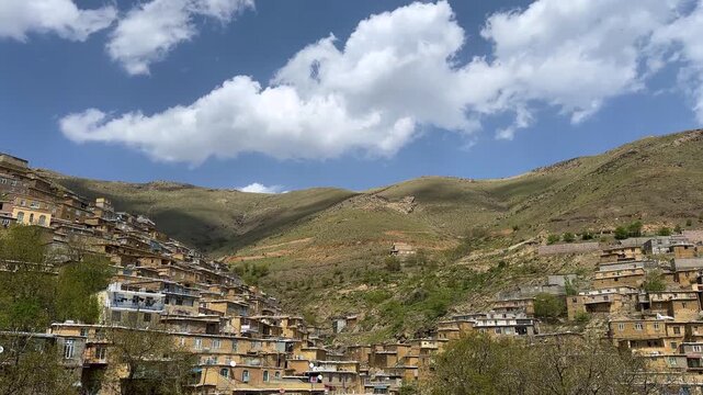 rolling shadows on mountain landscape local people lifestyle brick mud house Iran traditional rural village Kurdistan alpine landscape majestic peaks panoramic view spring greenery untouched nature
