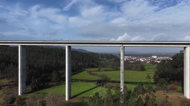 Tall viaduct road over farming fields valley