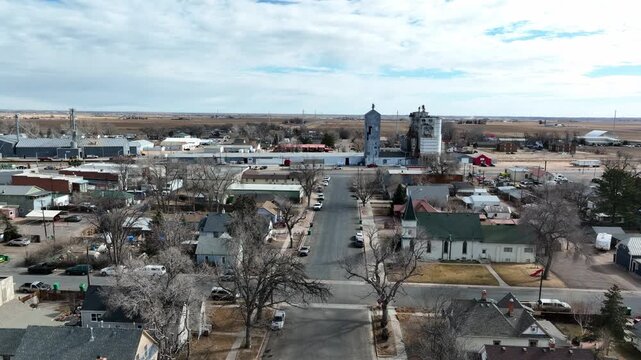 Ault Colorado agricultural town. Drone rise to show silos and railroads.