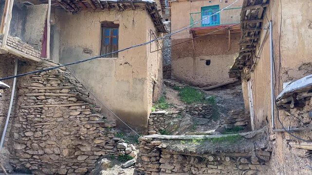 winding lane alleyway traditional stone terraced village cascade architecture in Iran scenic stepped brick Kurdistan rugged slope Zagros mountain local landscape earthen roof structure rustic timber