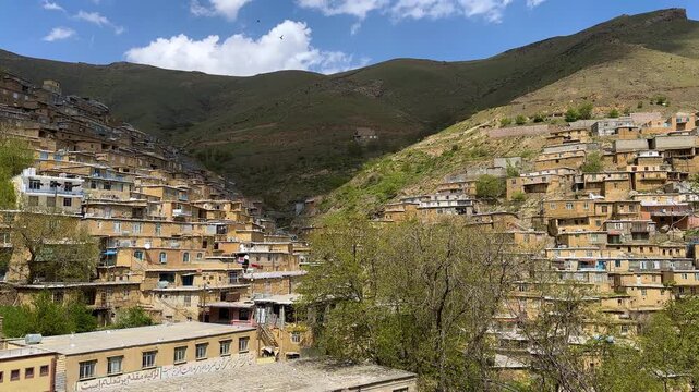 cloud shadow rise on mountain blue sky white cloud village Iran Kurdish people nature Kurdistan vivid peaceful scenic stepped brick rugged slope Zagros stone traditional architecture terrace courtyard