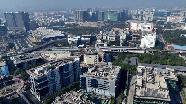 Sunrise over HITEC City reveals a living tech hub. A calm morning view of Deccan Park, with modern workspaces rising beside the metro and lush urban greenery below.