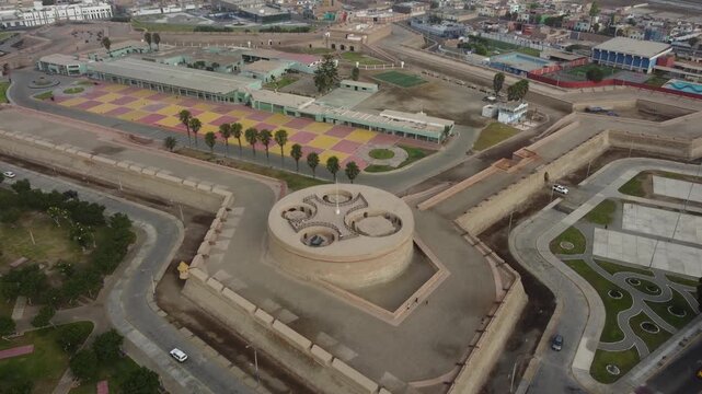 Aerial shot of a 18th-century Spanish military pentagonal fortress near the coast of the Pacific ocean. Drone slowly orbits around and tilts camera up. Located in the city of Callao in Peru.