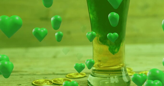 Tall narrow glass, green hearts appearing and causing dye swirling into yellow liquid for holiday