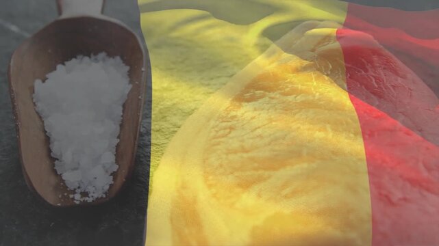 Camera panning right, yellow sauce spreading over raw meat, salt scoop, flag waving for seasoning