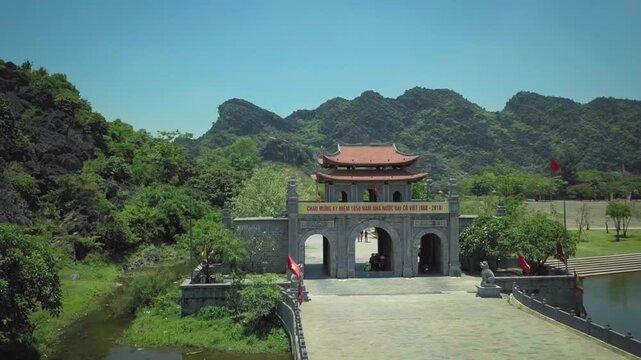 Majestic aerial view flying away from the hoa lu ancient capital entrance gate in ninh binh