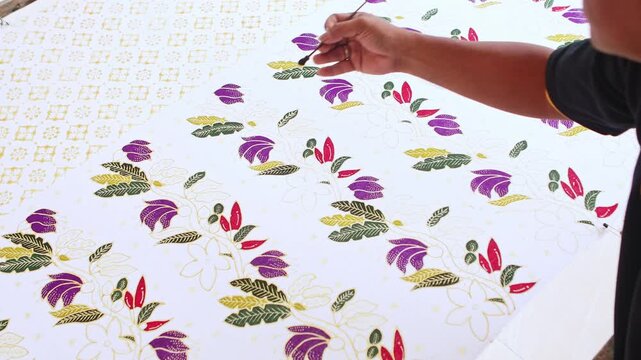 Artisan painting traditional Indonesian batik cloth by hand
